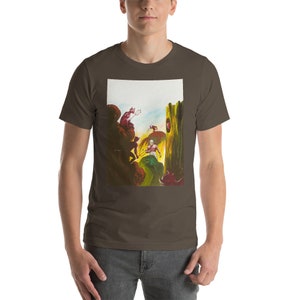 May include: A brown t-shirt with a colorful illustration of a man fighting off several red demons in a jungle setting. The illustration is framed by a white border.