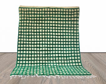 Moroccan berber green and white grid area rug.