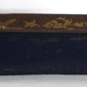 May include: A blue metal tin with a gold trim and the words "50 GRAM" printed on the bottom.