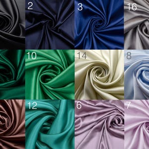 May include: A collection of 16 different colors of satin fabric swatches. The swatches are arranged in a grid of four rows and four columns. Each swatch is folded in a spiral shape.