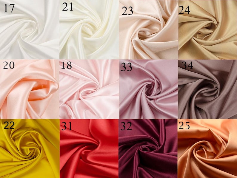 May include: A collection of 10 fabric swatches in various colors, including white, cream, peach, pink, brown, yellow, red, burgundy, and orange. The fabric is a smooth, silky satin.