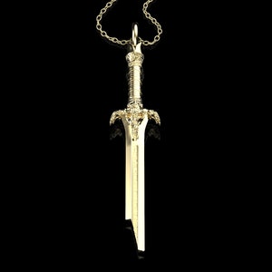 May include: A gold-coloured sword pendant necklace. The sword has a detailed design with a pointed tip and a decorative handle.