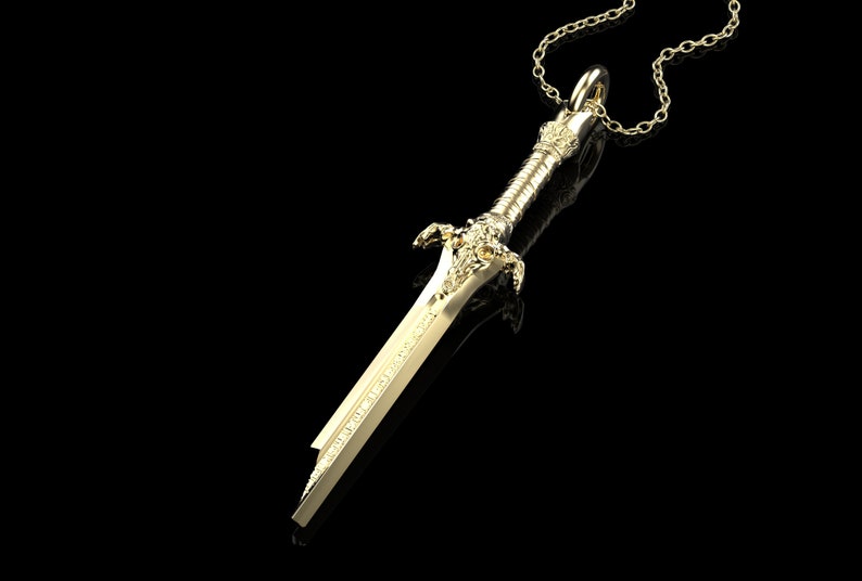 May include: A gold-coloured sword pendant necklace. The sword has intricate details and a chain attached to the top.