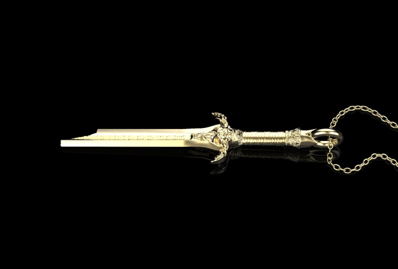 May include: A gold sword pendant necklace with a detailed design and a chain. The pendant is approximately 5 cm long.