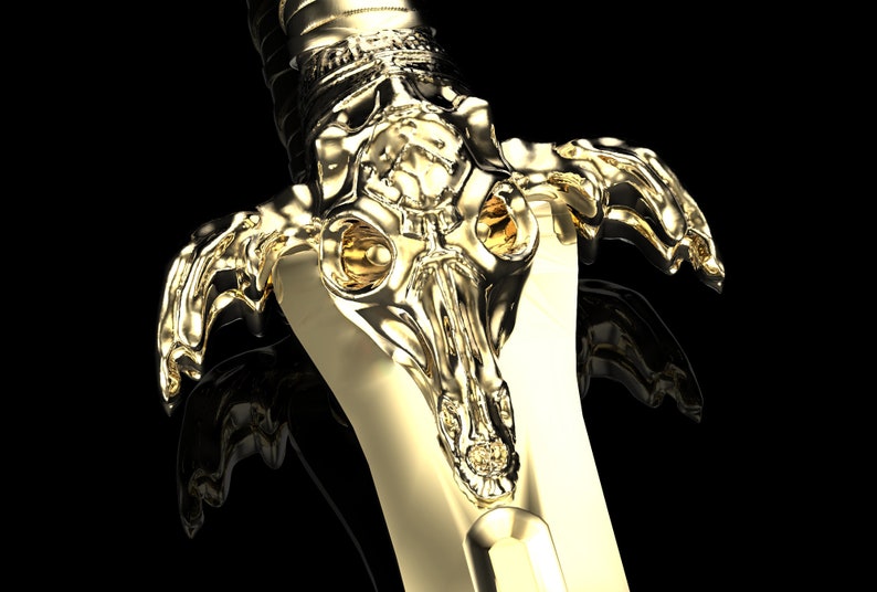 May include: A gold-coloured sword with a detailed, skull-like hilt. The hilt is intricately designed with a textured surface and features two large, round, yellow eyes.