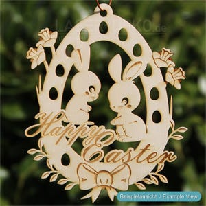 May include: Wooden Easter egg decoration featuring two cartoon bunnies facing each other. The words "Happy Easter" are carved into the wood, along with a bow and floral accents. The decoration is made of light-colored wood.