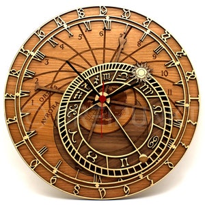 May include: A wooden clock with a circular face featuring Roman numerals and a detailed zodiac design. The clock has a gold-colored trim and a brown wooden background.