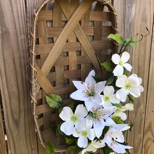 large white tobacco basket Whitewashed With and Navy Flowers Hang them in a grouping on the wall for that farmhouse feel Tobacco Basket Decor  Trendy