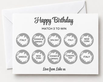 May include: A white birthday scratch-off card featuring the text Happy Birthday and MATCH 3 TO WIN. It includes ten gray circular scratch-off areas with text underneath, including Italy, Dinner & Drinks, Spa Day, New York, Greece, and Cinema Trip, with Love from Luke xx at the bottom.