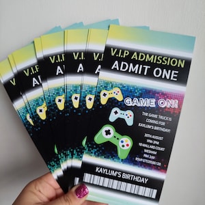 May include: A stack of colourful VIP admission tickets for a birthday party with a video game theme. The tickets feature a green and black gamepad graphic and the text "Game On!" and "Kaylum's Birthday".