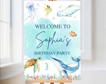May include: Welcome to Sophia's Birthday Party sign with a blue watercolor background and sea creatures including a whale, a turtle, a jellyfish, a fish, and a seahorse.