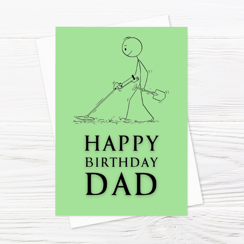 May include: A green card with a stick figure illustration of a person holding a metal detector and a shovel. The text "HAPPY BIRTHDAY DAD" is printed in black.
