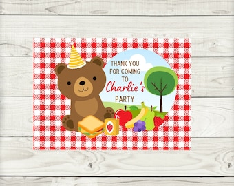 May include: A party invitation featuring a brown bear wearing a party hat, set against a red and white checkered background. The invitation includes the text "Thank you for coming to Charlie's Party" with illustrations of food.