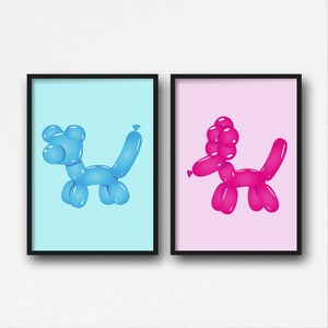 May include: Two framed art prints. One features a blue balloon dog on a light blue background. The other print shows a pink balloon dog on a pink background. Both prints have black frames and are displayed against a white wall.