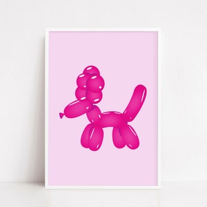 May include: A framed print featuring a pink balloon dog illustration. The dog is depicted in a playful pose, with a rounded head, body, and tail. The background is a soft pink, and the print is encased in a white frame.