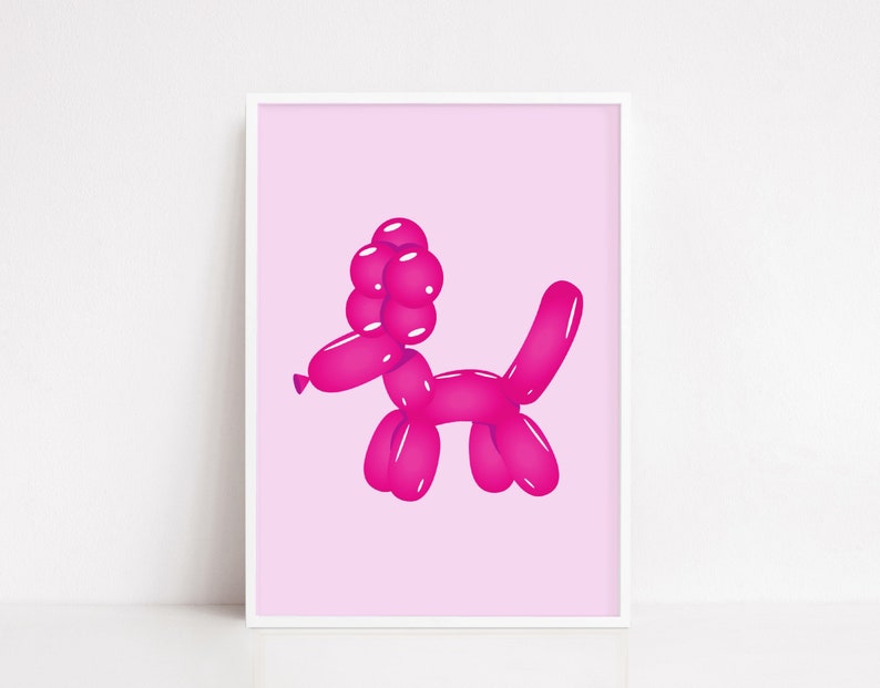 May include: A framed print featuring a pink balloon dog illustration. The dog is depicted in a playful pose, with a rounded head, body, and tail. The background is a soft pink, and the print is encased in a white frame.
