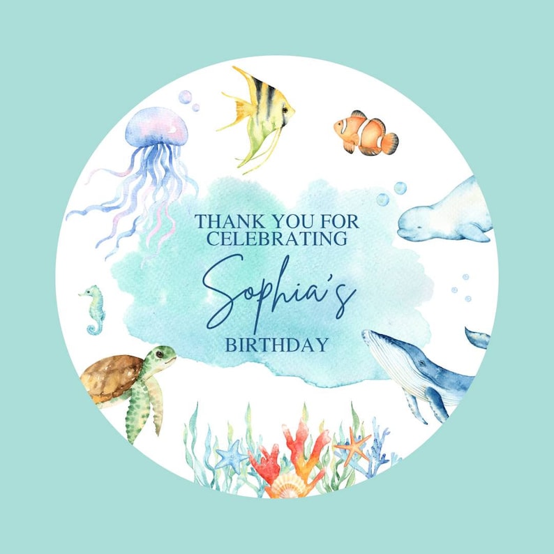 May include: A round, white sticker with a watercolor background featuring a blue whale, a seahorse, a turtle, a jellyfish, a clownfish, a beluga whale, and coral. The text "Thank you for celebrating Sophia's Birthday" is written in blue.