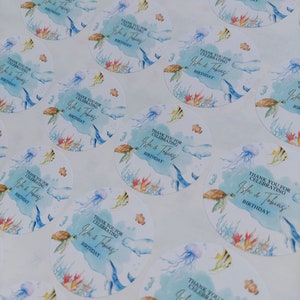 May include: Round stickers with a watercolor design of a turtle, jellyfish, and fish. The stickers say "Thank you for celebrating Isla & Tobias' Birthday."