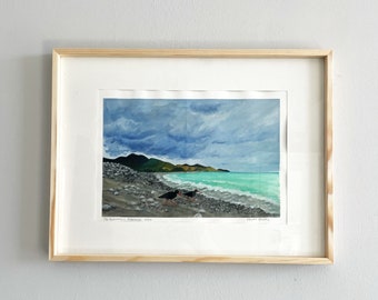 May include: Framed watercolor painting of a beach scene with three black birds on the shore. The sky is cloudy and the water is turquoise. The painting is titled "The Rumantara, Fitzroy, 2020" and signed "Peter Graham".