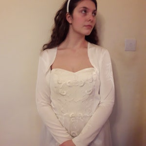 Wedding bolero  in ivory or white silky jersey fabric, long sleeved cover up for the bride, cut away neckline and embroidered edges.