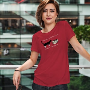 May include: Red t-shirt with a black and white cat illustration and the text "Ignorance killed the cat. Curiosity was framed."