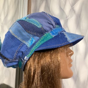 May include: A white ceramic mug with a black handle and the text "But First, Coffee" in a black, handwritten-style font. The mug is on a white surface.