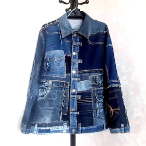 May include: A patchwork denim jacket in various shades of blue. The jacket features a collared neckline, button closures, and multiple pockets. The design incorporates different denim pieces, creating a unique, textured appearance. The jacket is hanging on a black hanger.