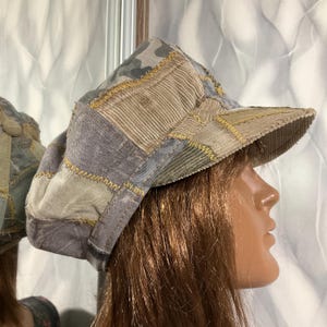 May include: A white ceramic mug with a black handle and the text "But First, Coffee" in a black, handwritten-style font. The mug is on a white surface.