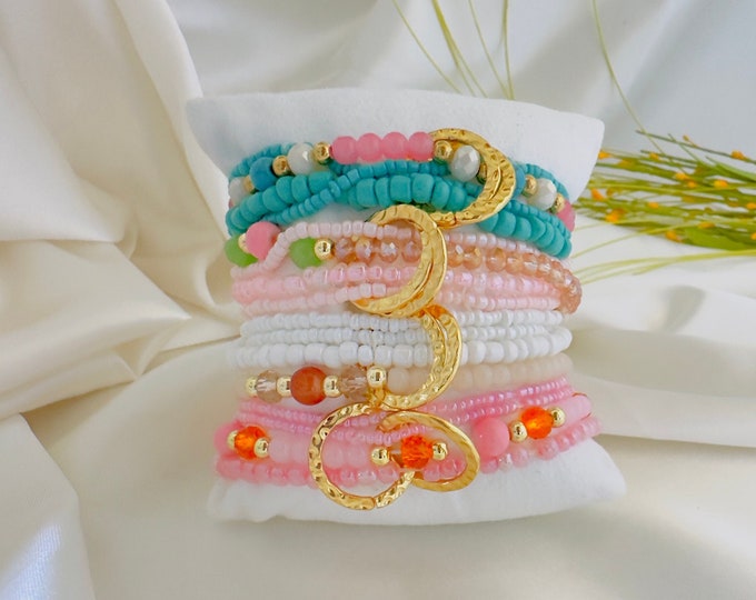 Vibrant beaded bracelets accompanied by golden touches