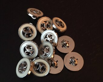 Twelve silver and white patterned buttons