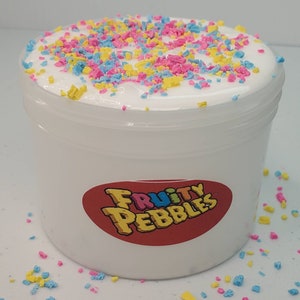May include: White slime with colorful sprinkles in a clear plastic container with a red and white label that says "Fruity Pebbles".