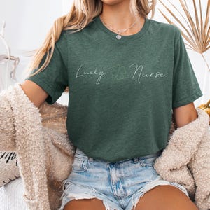 May include: A green t-shirt with the text "Lucky Nurse" in white script with a four-leaf clover graphic.