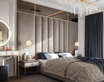 May include: A bedroom with a large bed with a beige headboard and a beige quilted comforter. The bed has two white pillows and two black pillows. There are two bedside tables with lamps on them. The room has a large mirror and a vanity with a stool. The walls are white and the curtains are dark gray.