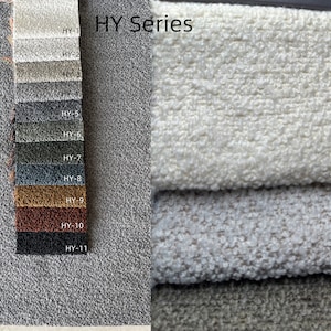May include: A fabric swatch card labeled "HY Series" displays various textured fabric samples in shades of gray, beige, and brown. The card includes eleven numbered fabric swatches. Several larger fabric samples are stacked on the right, showcasing the texture.