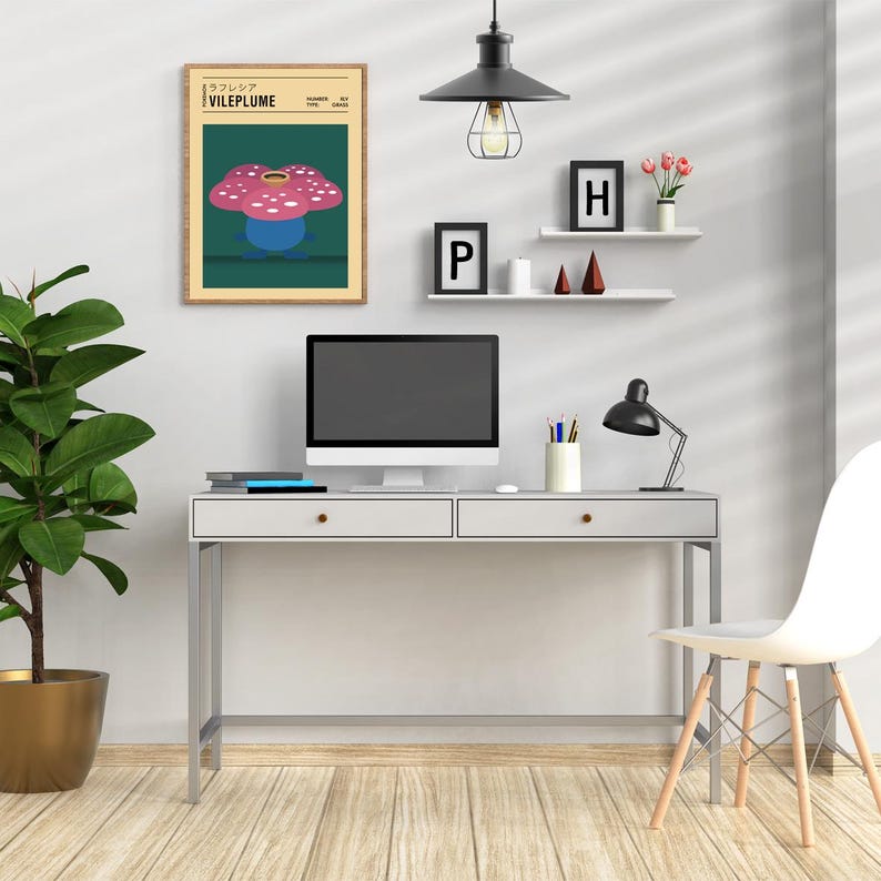 May include: A white desk with two drawers and a black computer monitor on top. There is a black lamp with a white shade on the desk. There is a framed print of a pink and blue flower with the text "VILEPLUME" on it. There is a shelf above the desk with two small frames, one with the letter "P" and the other with the letter "H".