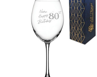 May include: A clear glass wine glass with an etched design that says "Name Happy 80th Birthday". The glass is in a blue and gold gift box.