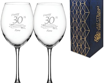 May include: Two clear glass wine glasses with etched text that reads "Happy 30th Anniversary Name". The glasses are in a blue and gold gift box.
