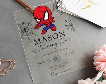 May include: A clear acrylic invitation with a cartoon image of Spiderman in red and blue. The invitation says "MASON is turning two!" and includes details for a superhero themed birthday party.
