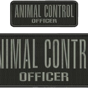 May include: Two black embroidered patches. The larger patch reads "ANIMAL CONTROL OFFICER" in white block letters. The smaller patch has the same text. Both patches have a black border.