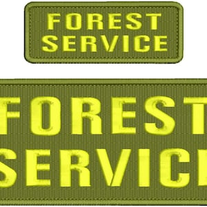May include: Two green patches with yellow text. The top patch reads "FOREST SERVICE". The bottom patch is larger and reads "FOREST SERVICE".