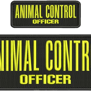 May include: Two black embroidered patches with yellow text. The larger patch reads "ANIMAL CONTROL OFFICER" in bold, block letters. The smaller patch has the same text. Both patches have a black border.