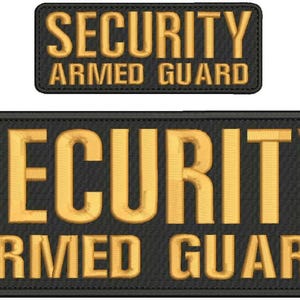 May include: Two black embroidered patches with gold lettering. The larger patch reads "SECURITY ARMED GUARD" in bold, block letters. A smaller patch with the same text is above the larger one. The patches have a stitched border.