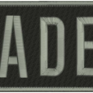 May include: A black patch with the word "CADET" embroidered in white.