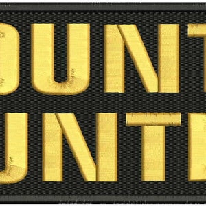 Peut inclure: Un écusson noir avec les mots "BOUNTY HUNTER" brodés en or.