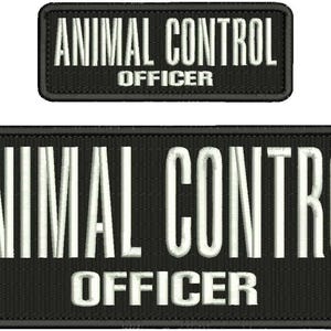 May include: Two black embroidered patches. The larger patch reads "ANIMAL CONTROL OFFICER" in white, block letters. A smaller patch above repeats the same text. Both patches have a black border.