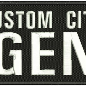 May include: Black and white embroidered patch with the text "CUSTOM CITY" and "AGENT" in white lettering.