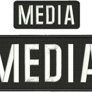 Peut inclure: Deux patchs brodés noir et blanc avec le mot "MEDIA" en lettres blanches.