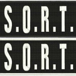 May include: Black and white embroidered patch with the text "S.O.R.T." in white lettering.