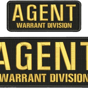 May include: Two black embroidered patches with gold lettering. The top patch reads "AGENT WARRANT DIVISION". The bottom patch reads "AGENT WARRANT DIVISION".