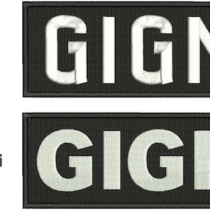 May include: Two black rectangular patches with white embroidered text that reads "GIGN". The top patch is labeled "Satin" and the bottom patch is labeled "Tatami".
